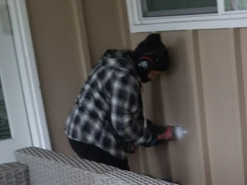 Professional electrician installing an exterior outlet in Weare